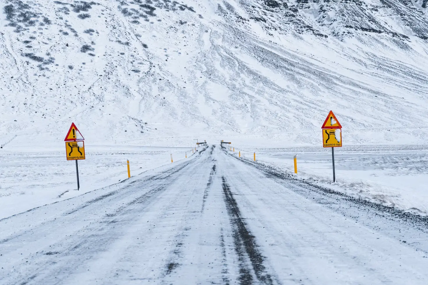 Non-invasive road state sensors and forward-scatter visibility meters installed on a highway for smart traffic safety management.